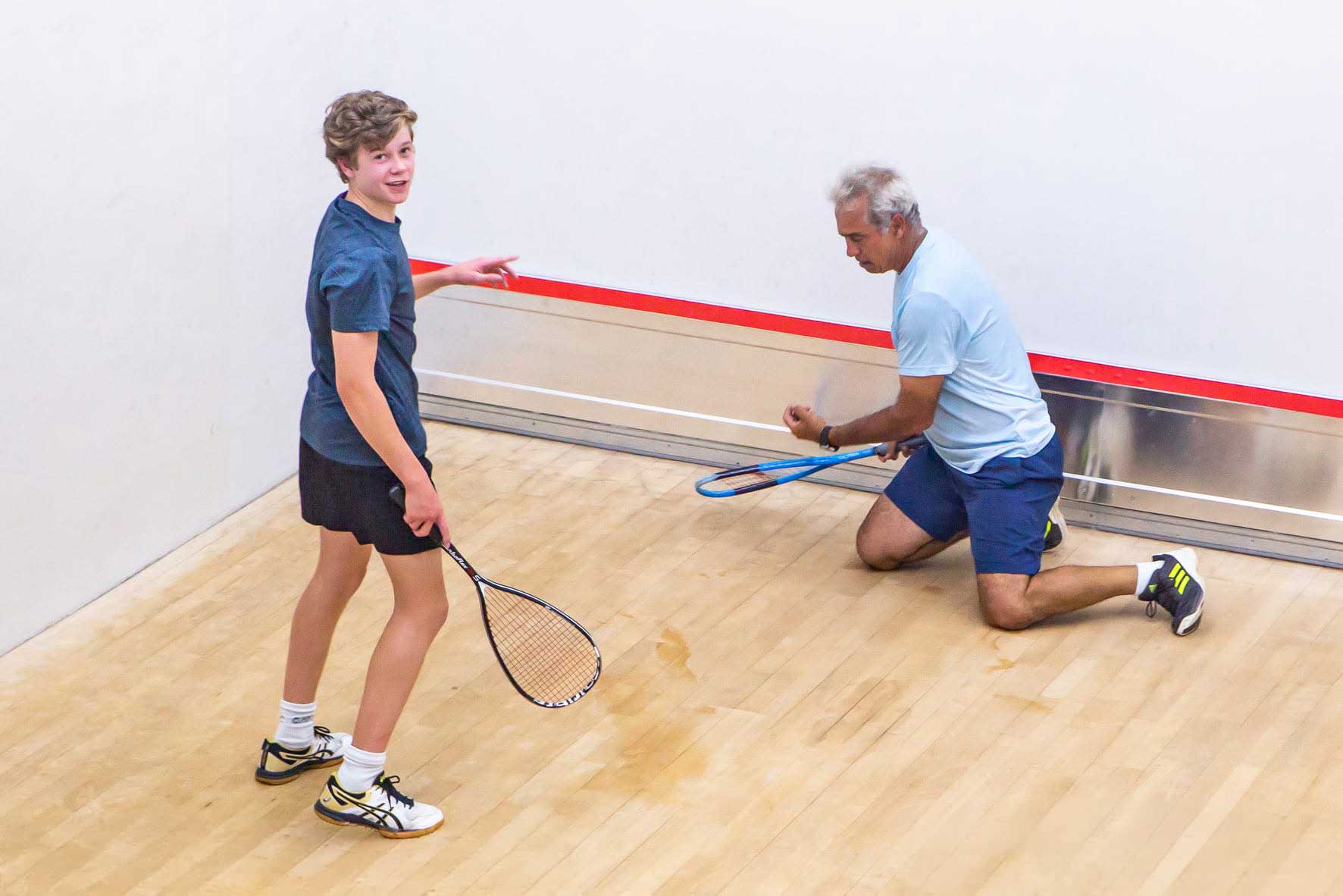 Junior coaching on a squash court
