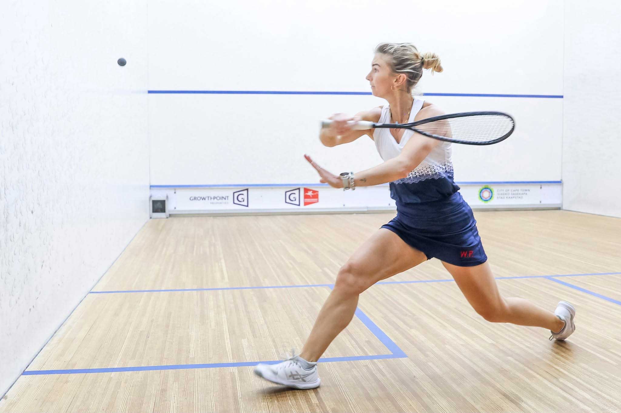 Player reaching for a squash ball